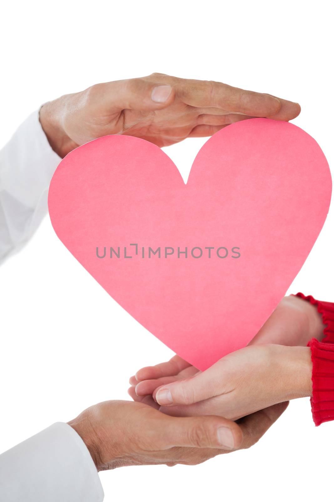 Close up of hands holding heart over white background