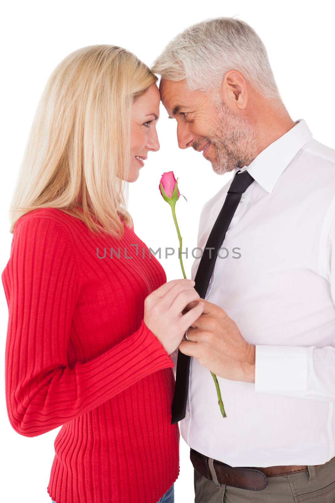 Romantic mature couple holding rose over white background