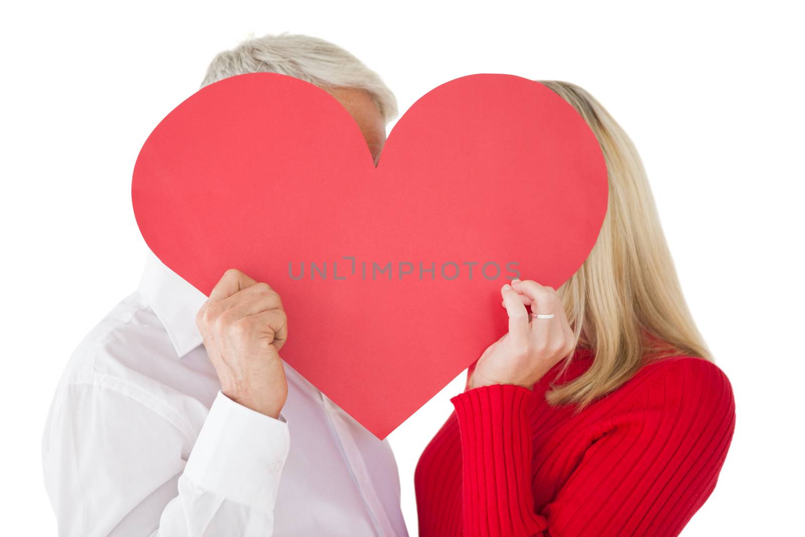 Mature couple holding heart over white background