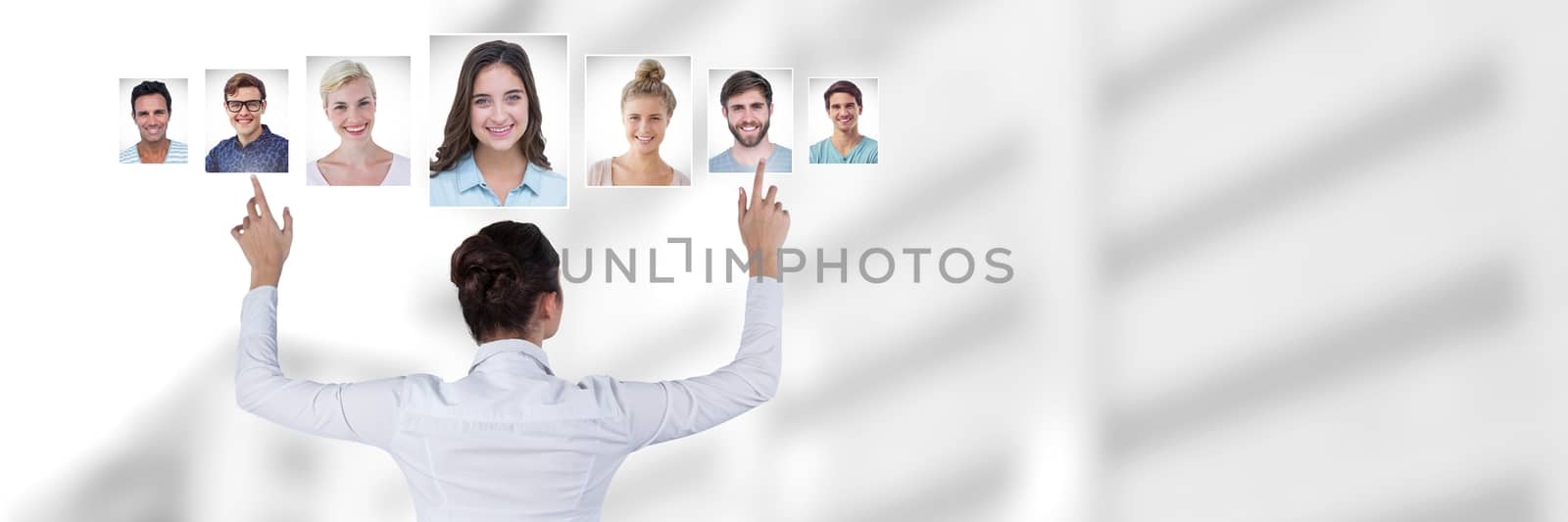 Digital composite of Woman touching portrait profiles of different people