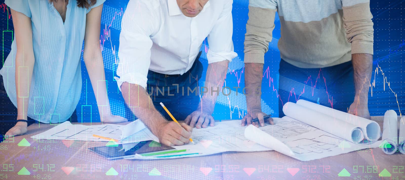 Business people discussing paperwork at desk against stocks and shares