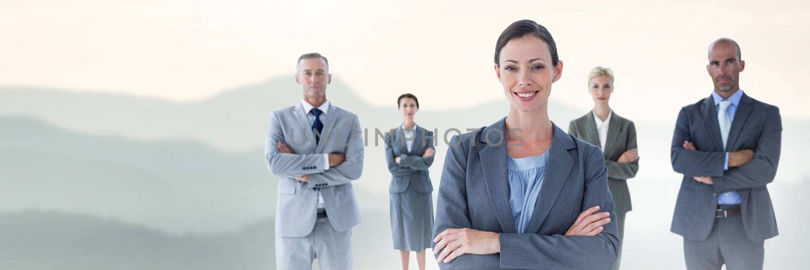 Digital composite of Business people and mountain landscape with flare light source