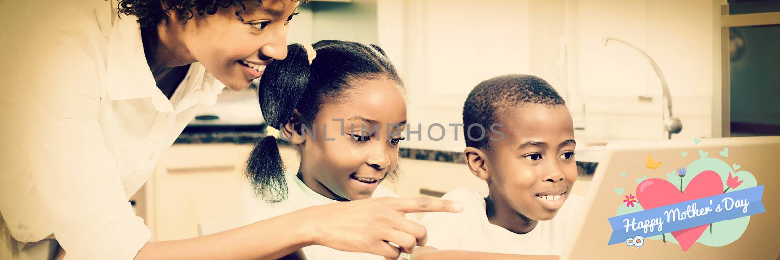 mothers day greeting against happy family using laptop in kitchen