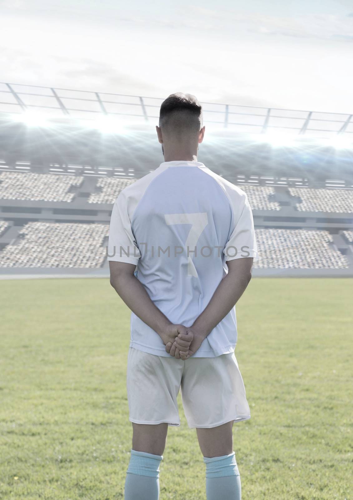 Digital composite of Soccer player standing in stadium on pitch