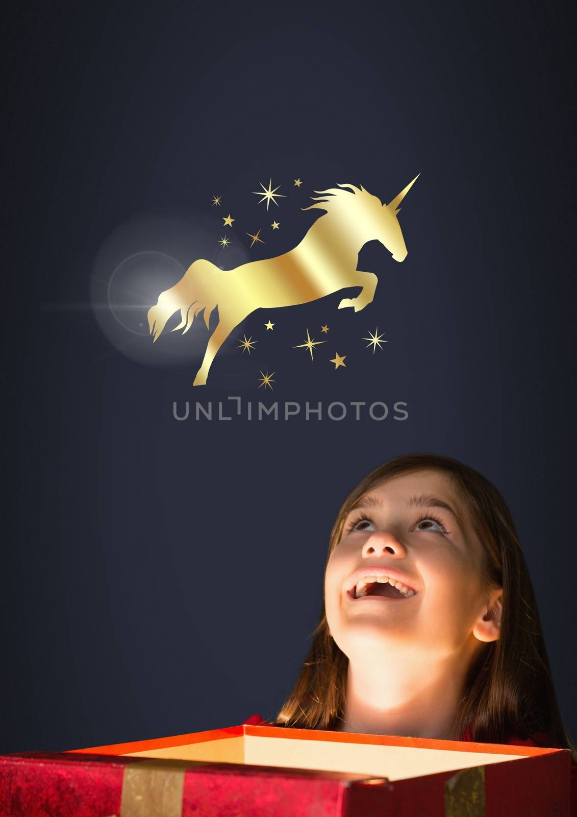 Digital composite of Golden unicorn and stars over magic light box and little girl