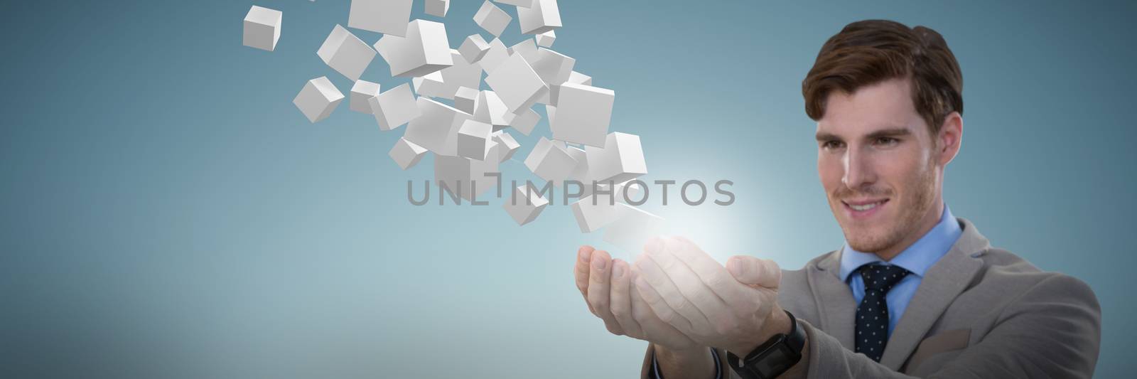 Businessman presenting object against abstract grey background