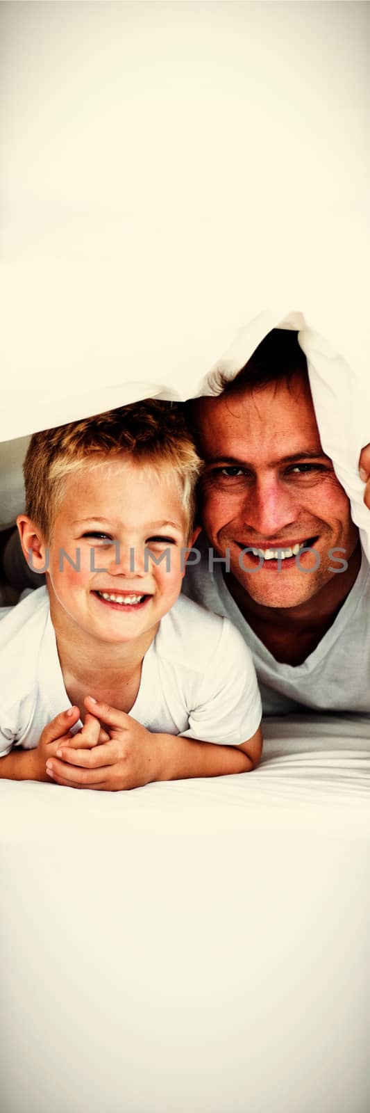 Young family playing together on a bed  by Wavebreakmedia