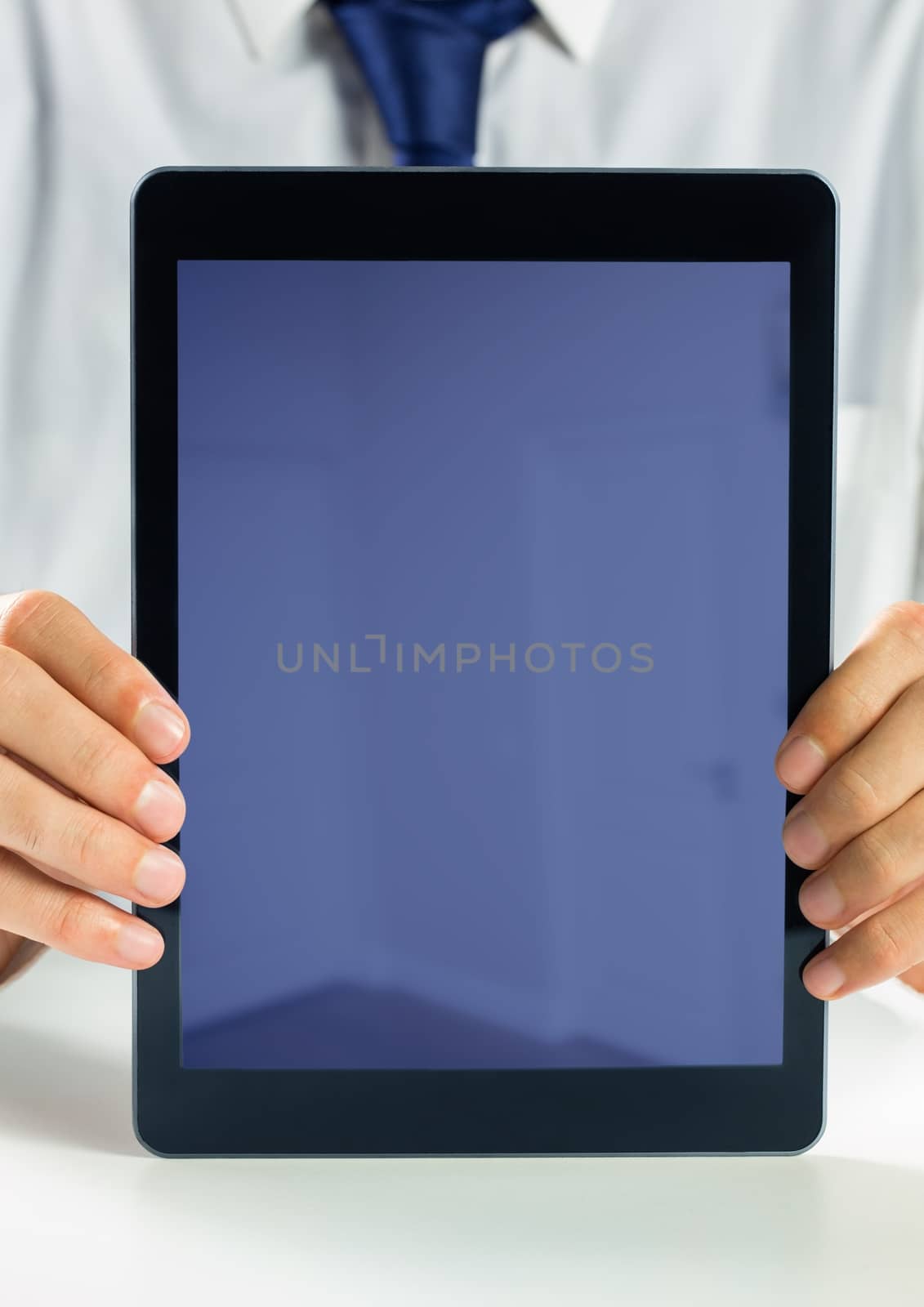 Digital composite of Holding blank screen tablet with businessman
