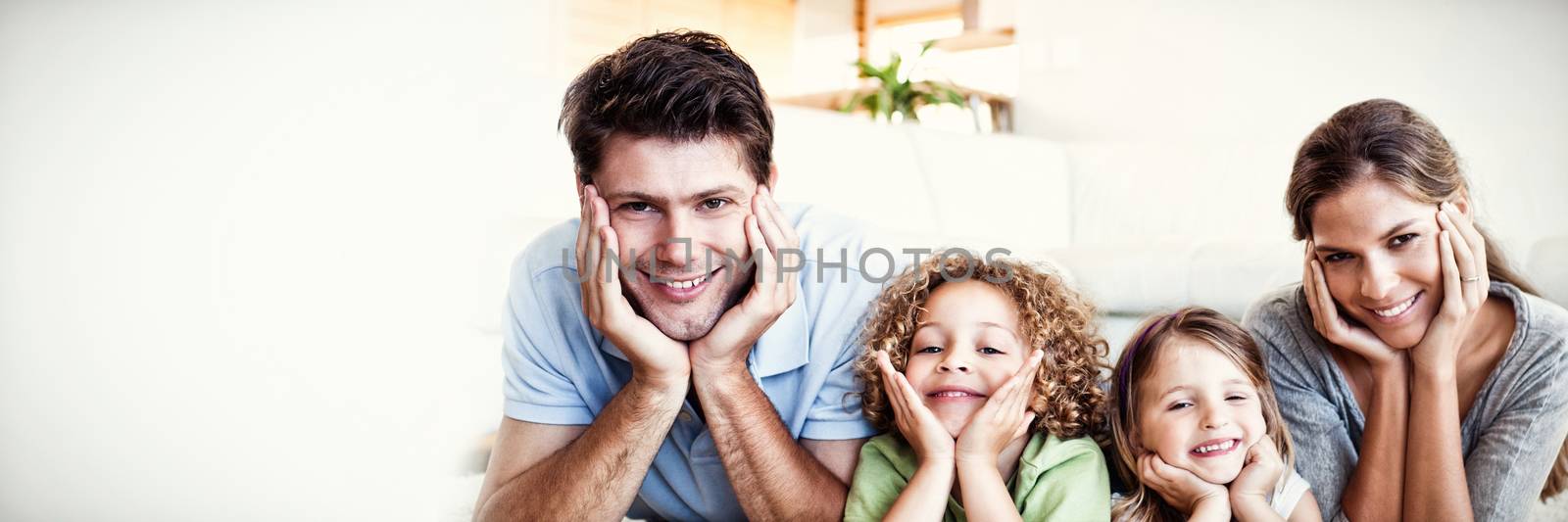 Family lying on a carpet in their living room