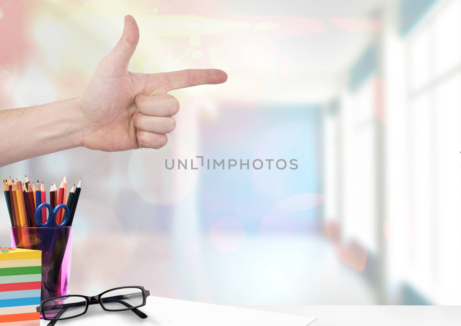 hand pointing with education objects by Wavebreakmedia