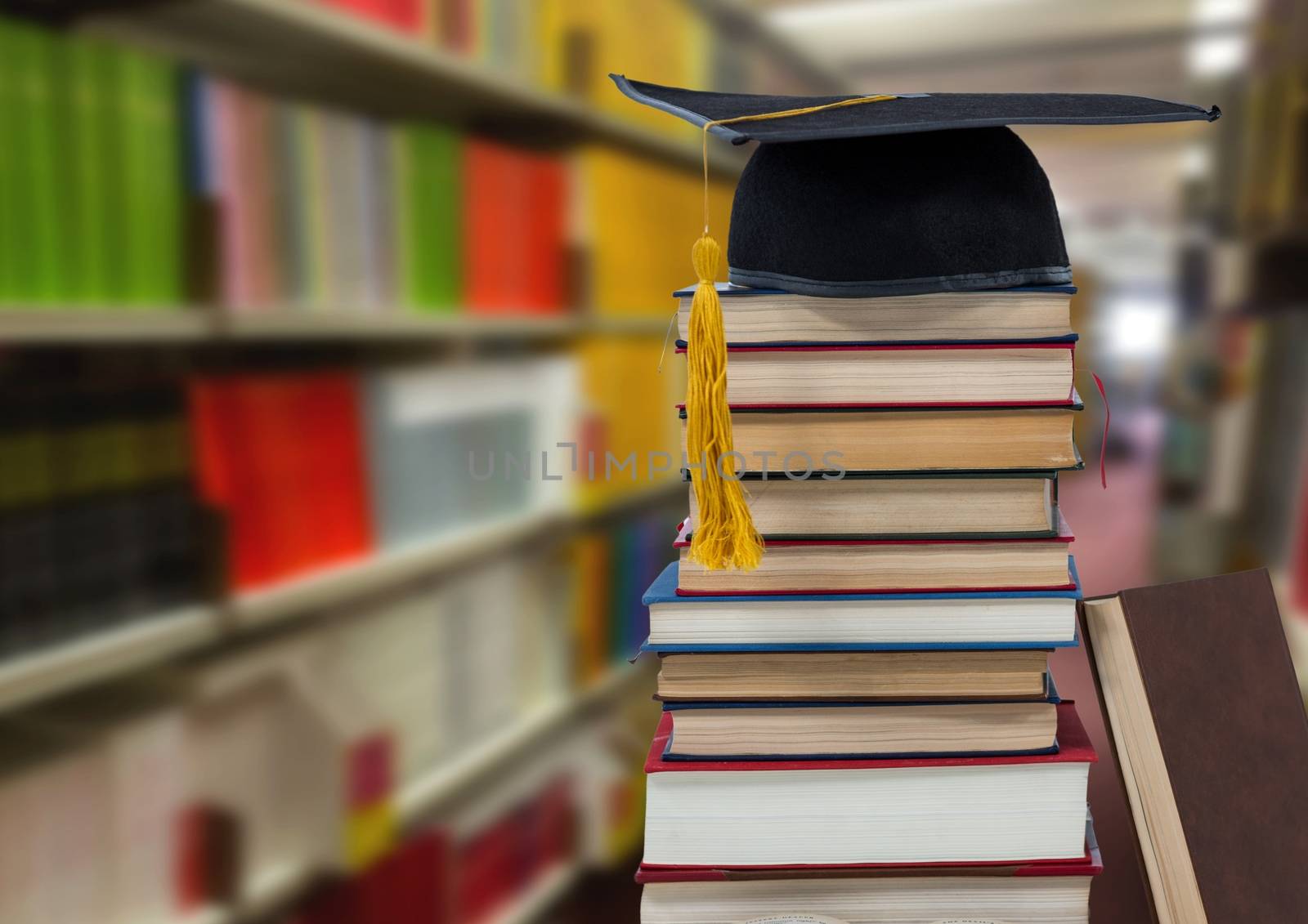 Books and graduation hat in education library by Wavebreakmedia