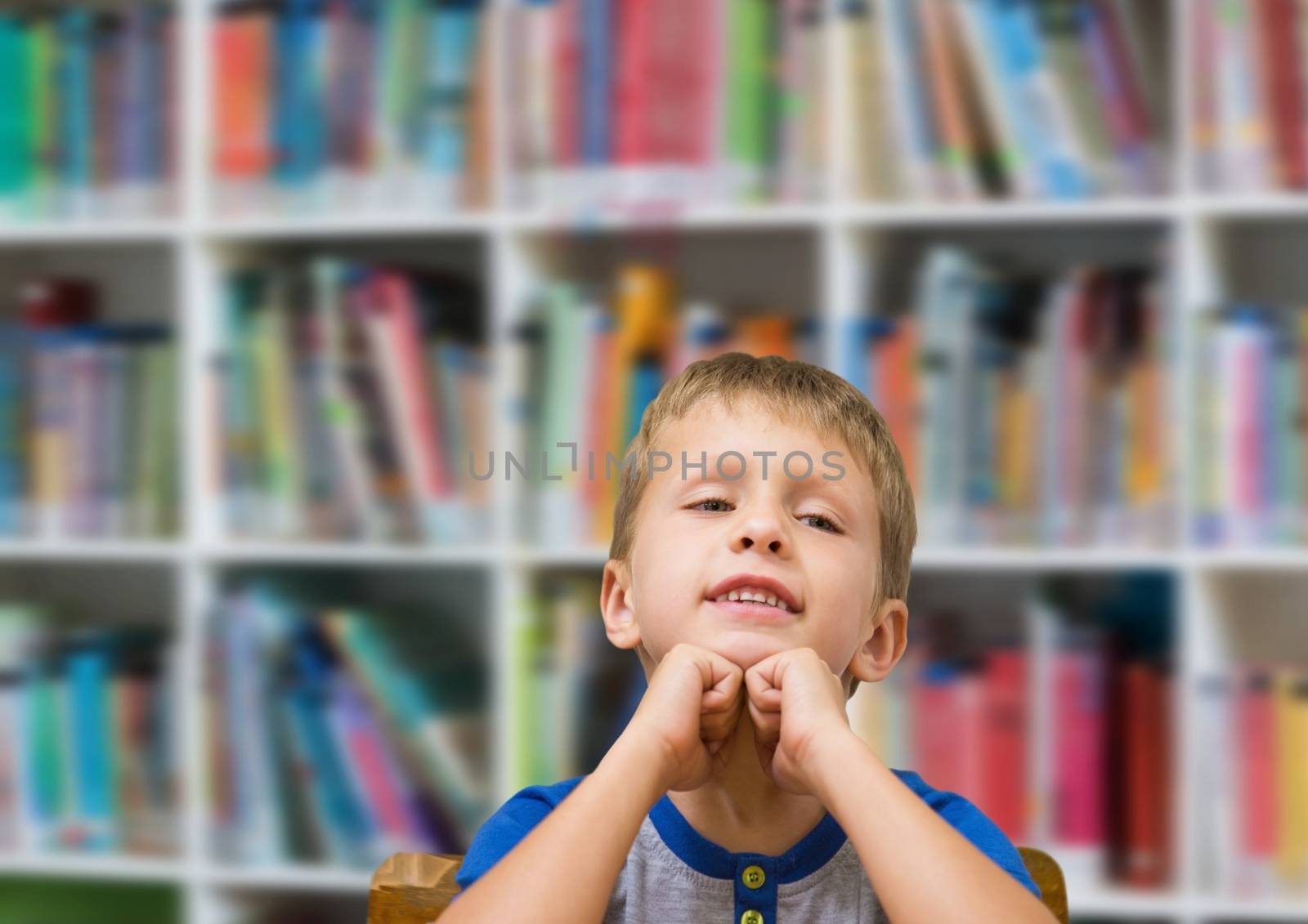 School boy in education library by Wavebreakmedia