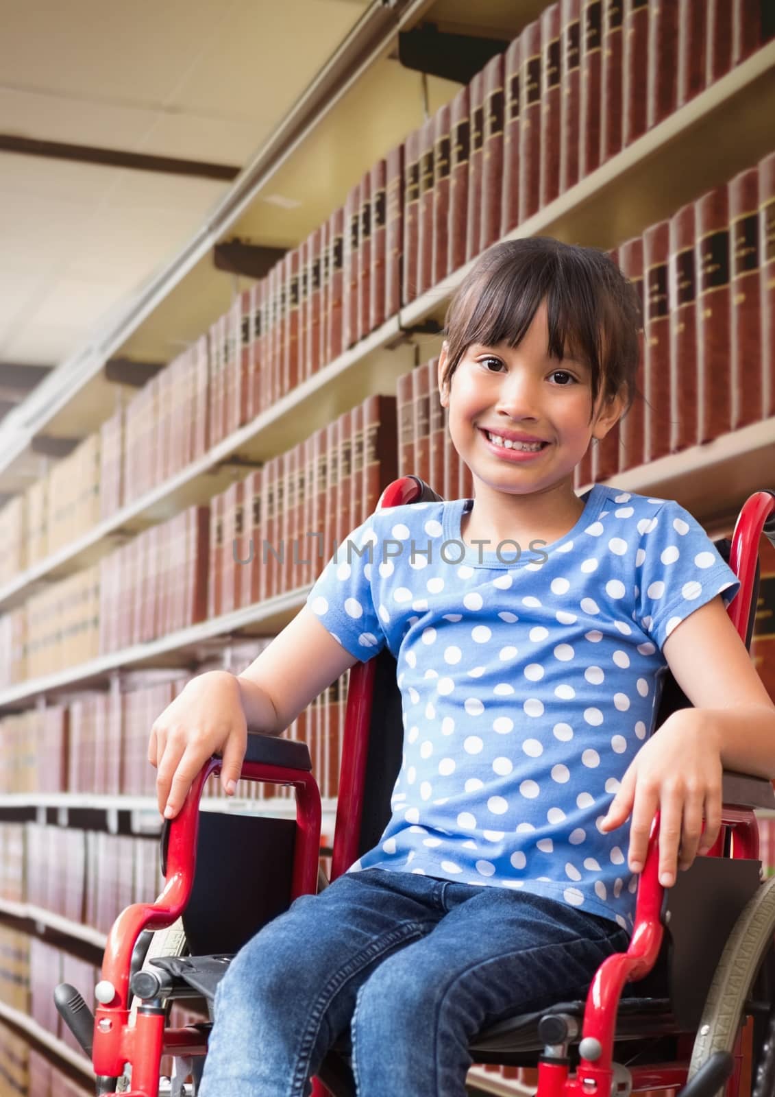 Disabled School girl in education library in wheelchair by Wavebreakmedia