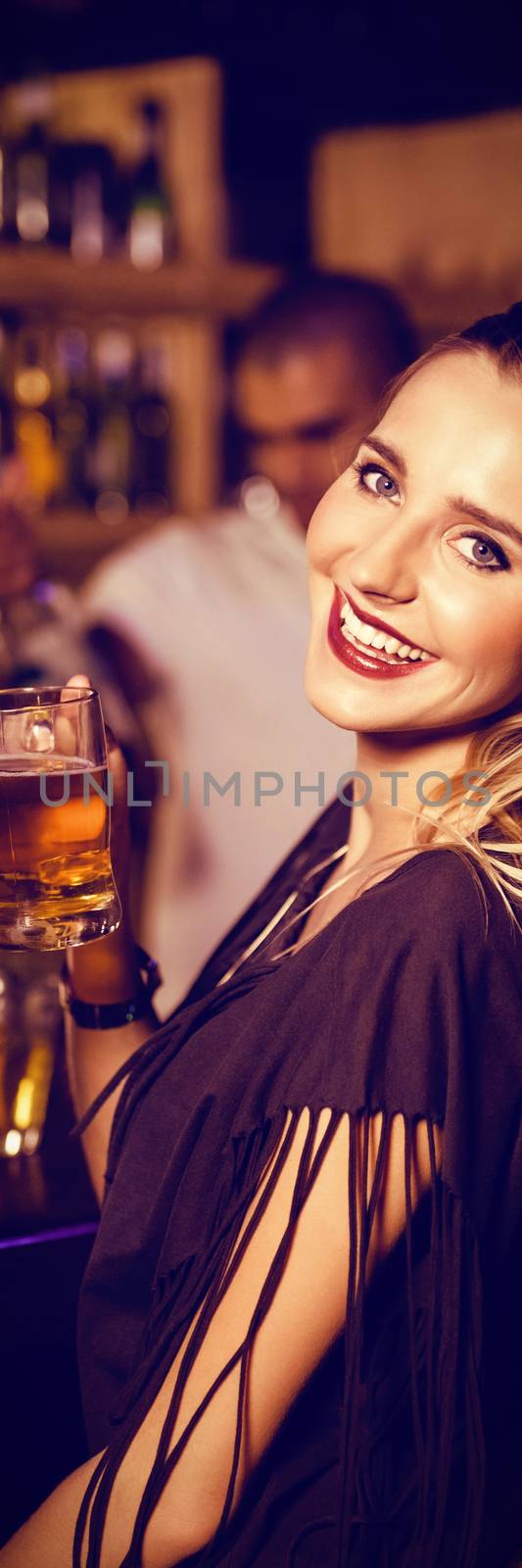 Portrait of beautiful female friends having drinks at counter in nightclub