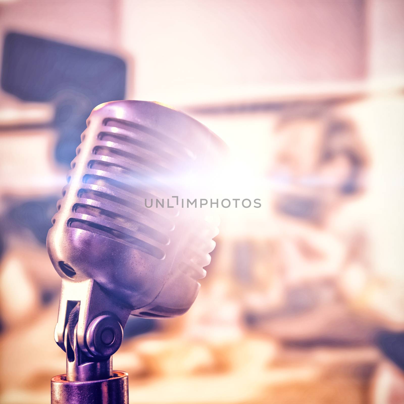 Close-up of microphone  against happy friends toasting beer at nightclub