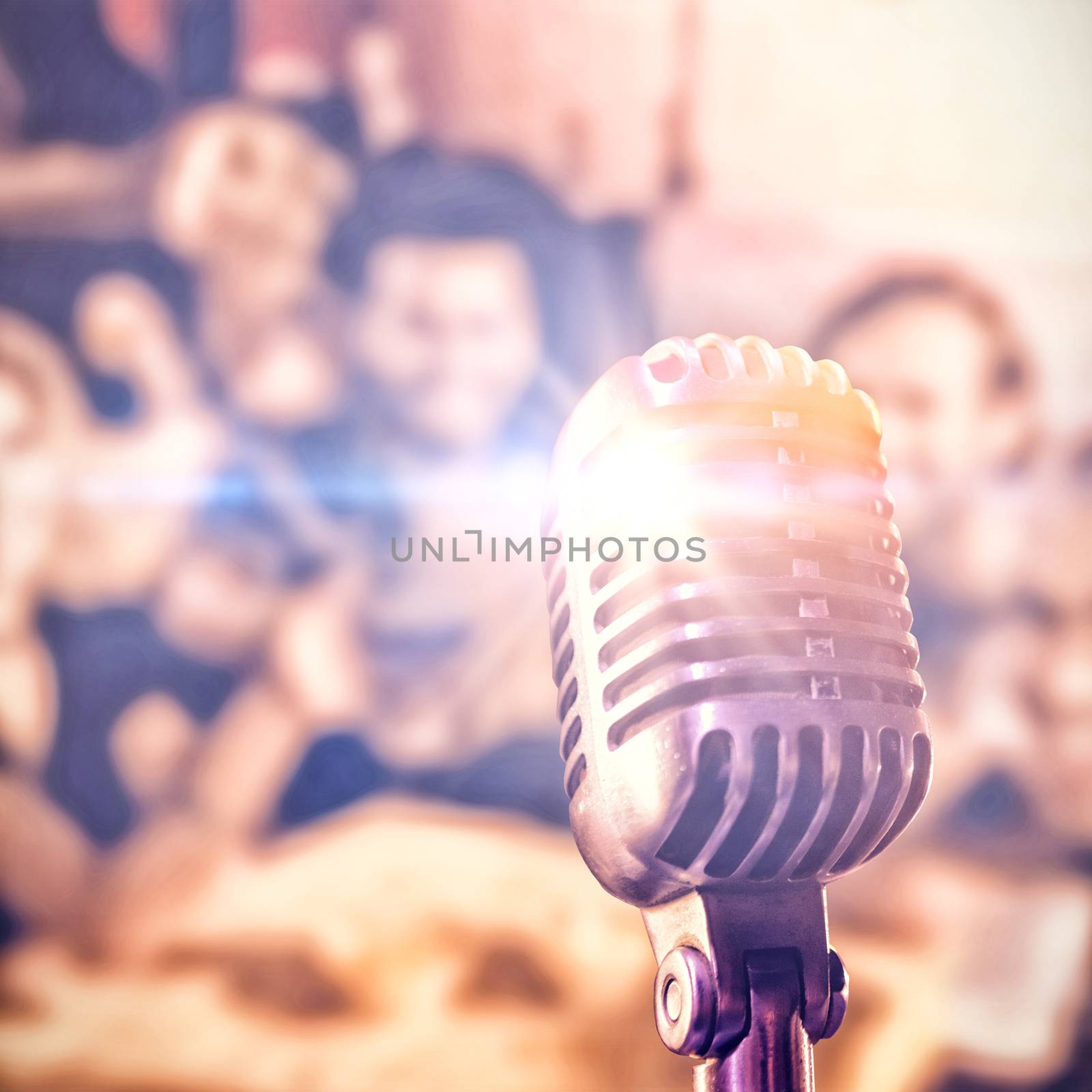 Close-up of microphone  against portrait of happy friends toasting beer at nightclub
