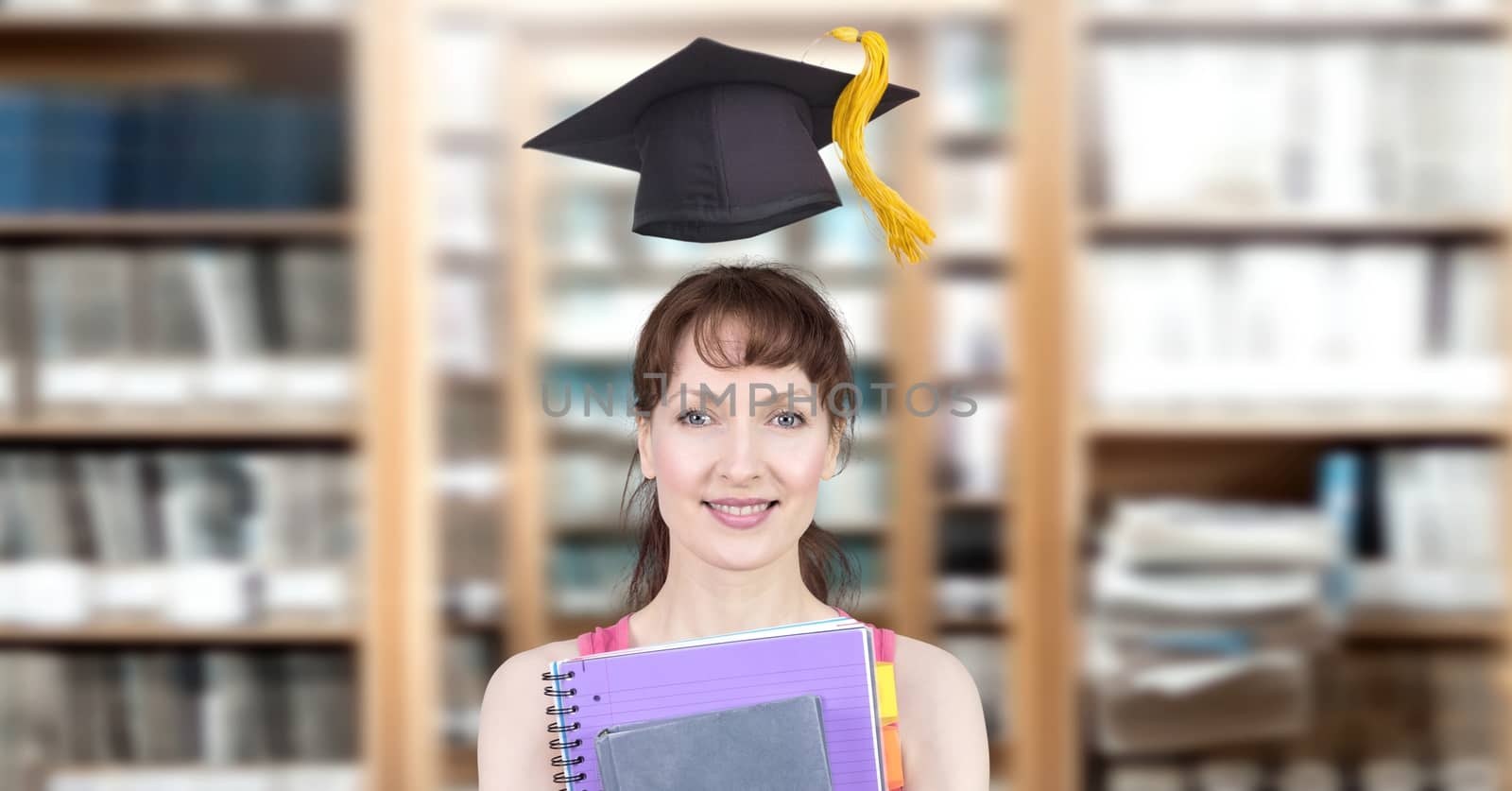 Digital composite of Student mature woman in education library with graduation hat