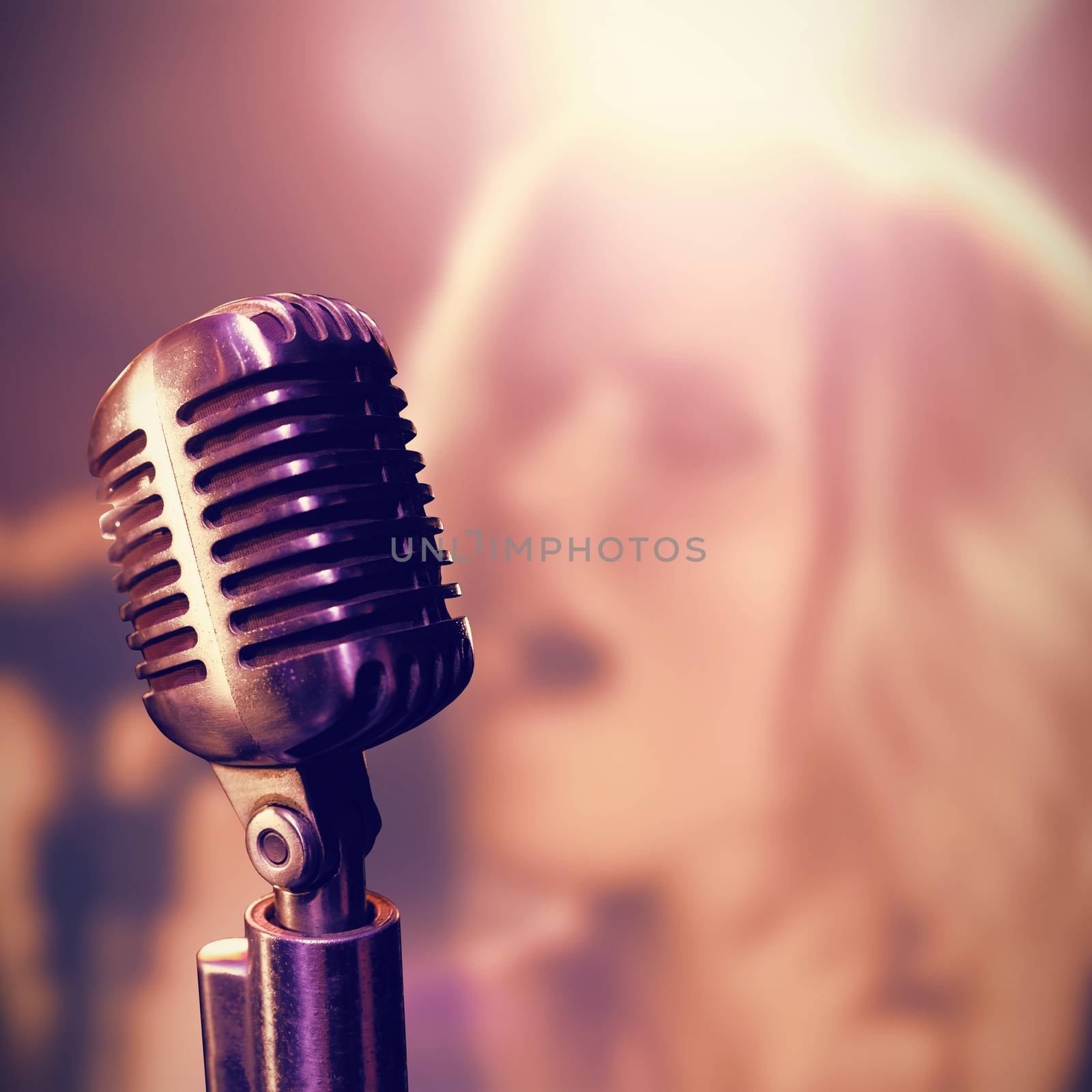 Close-up of microphone  against young female singer singing at nightclub