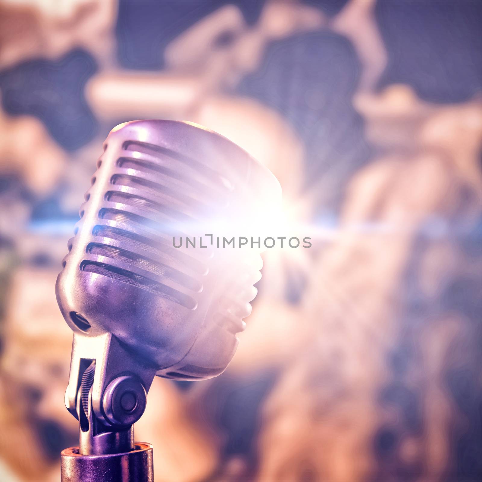 Close-up of microphone  against female friends toasting drinks in nightclub