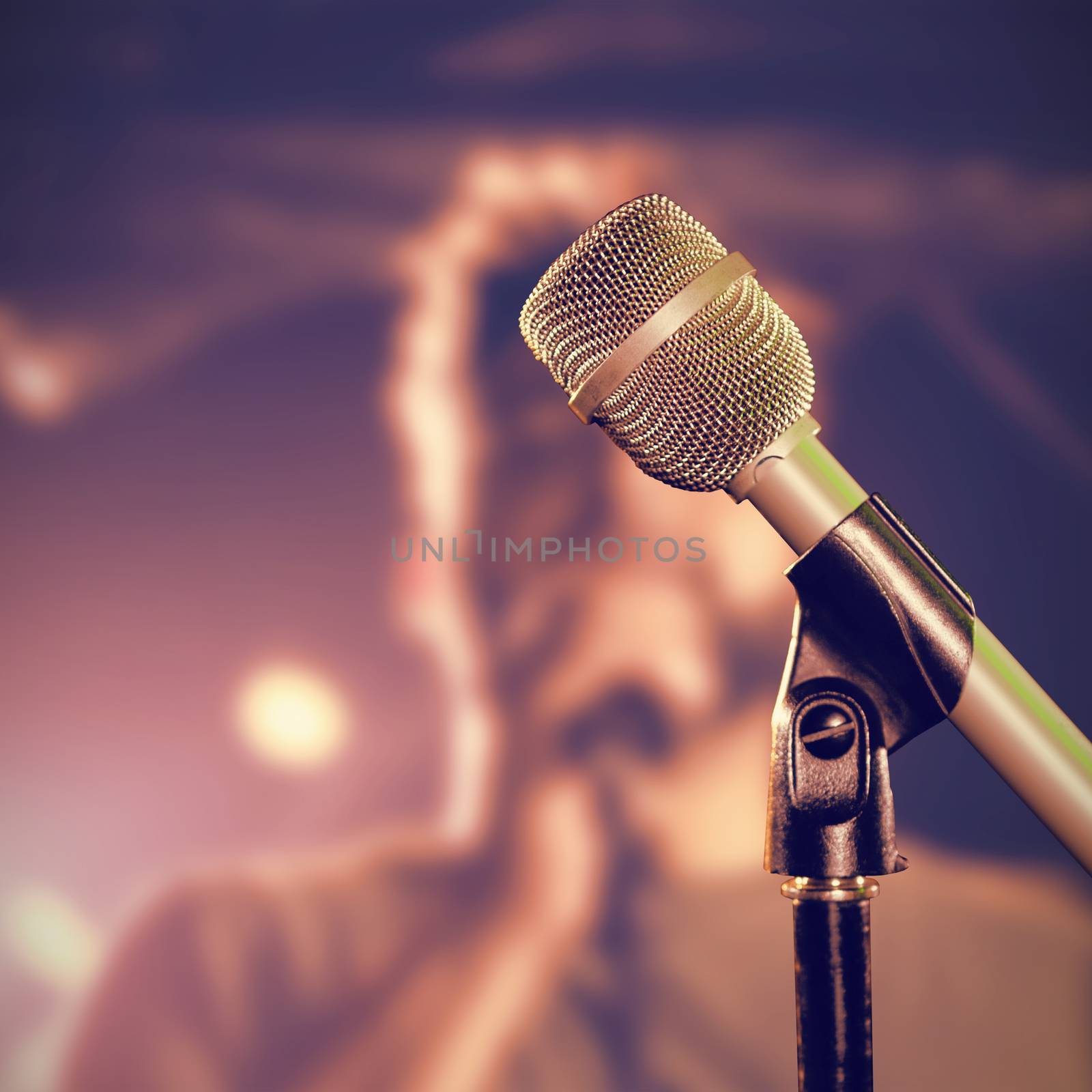 Close-up of microphone  against male singer performing at nightclub