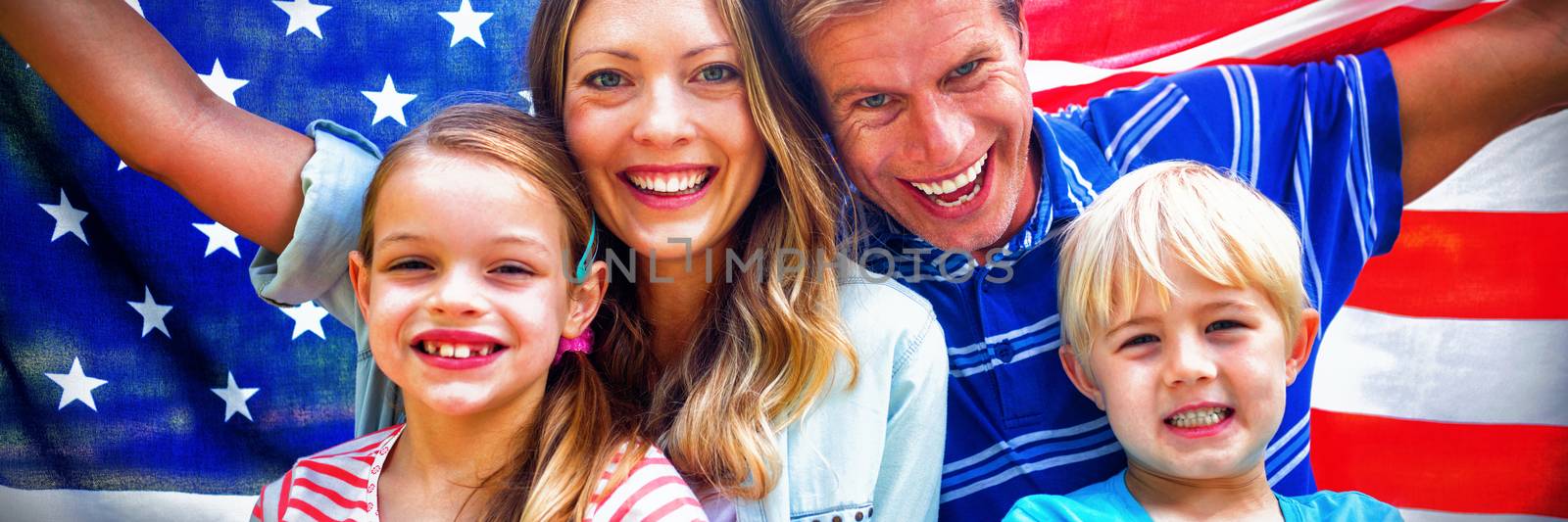 Hapy family holding american flag in the park by Wavebreakmedia