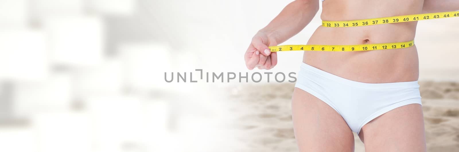 Digital composite of Woman measuring weight with measuring tape on waist on Summer beach with transition