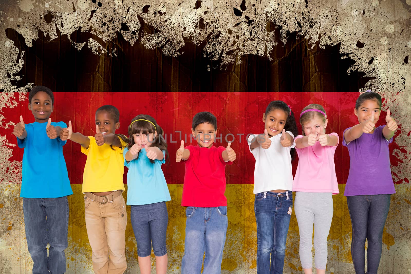 Composite image of elementary pupils smiling showing thumbs up by Wavebreakmedia