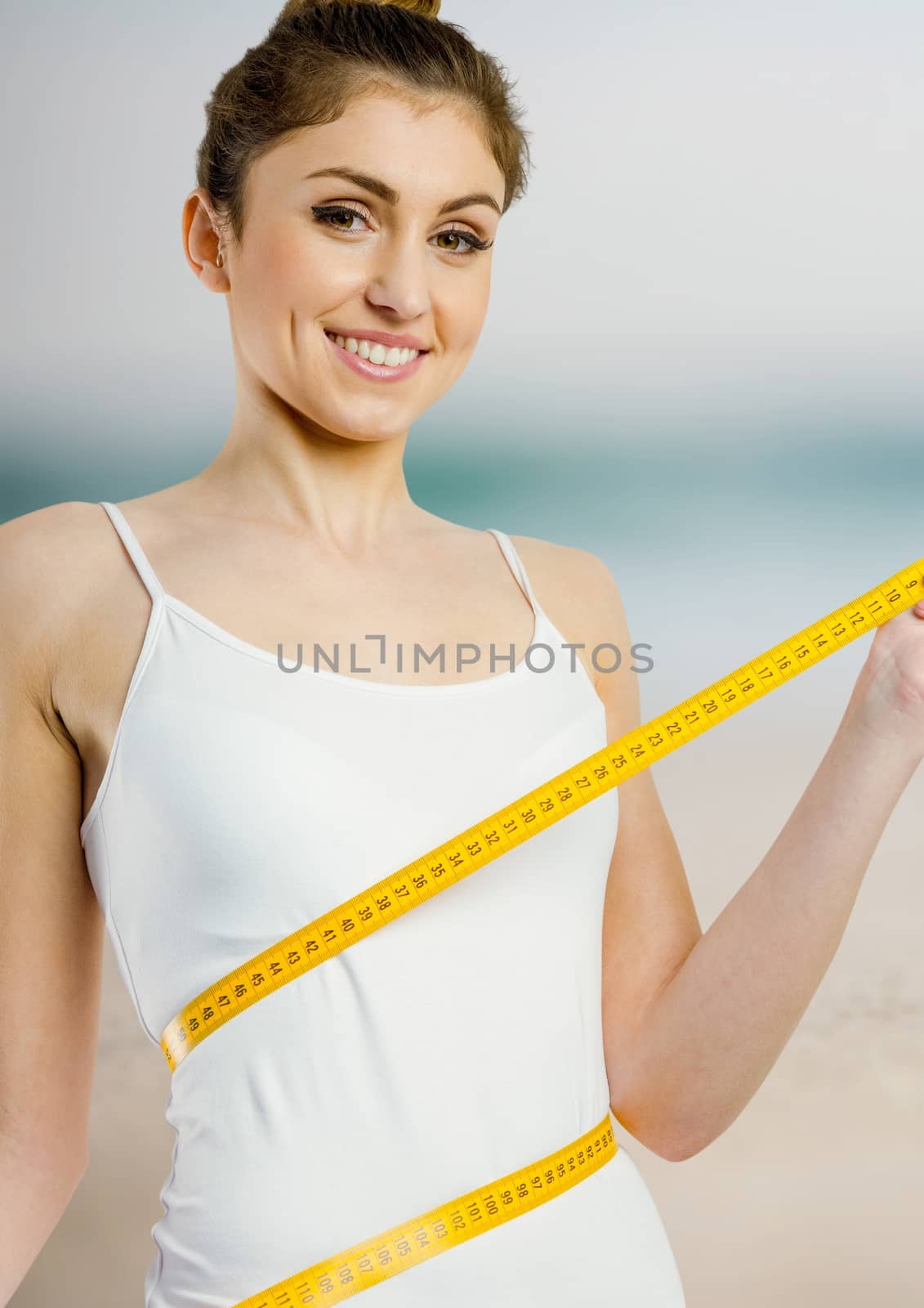 Digital composite of Woman measuring weight with measuring tape on waist on Summer beach