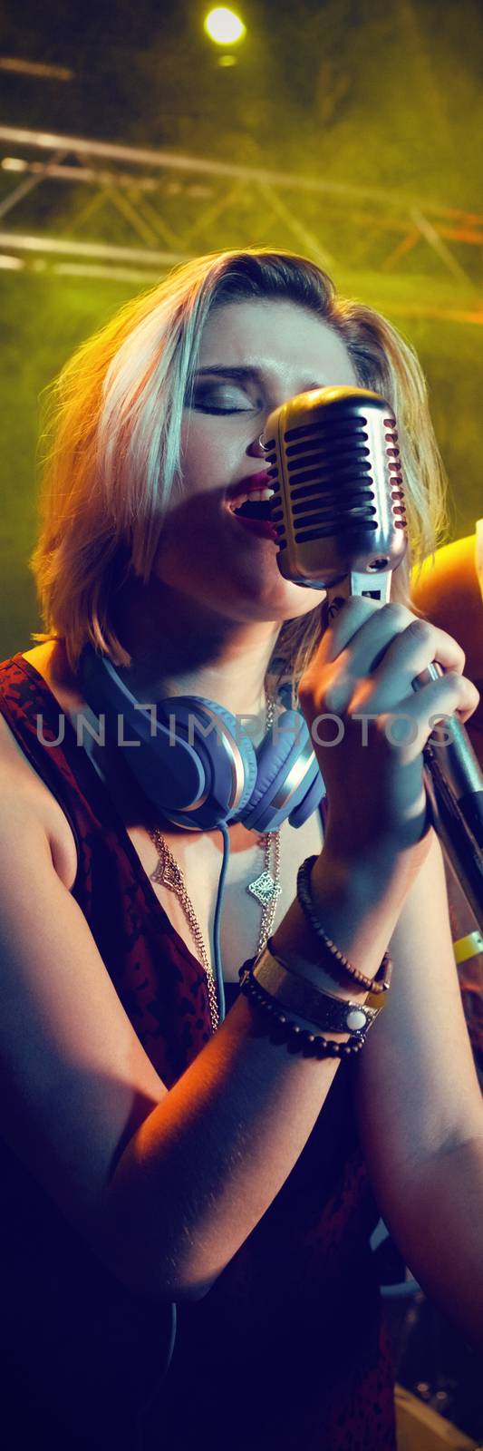 Guitarist looking at female singer on stage in nightclub