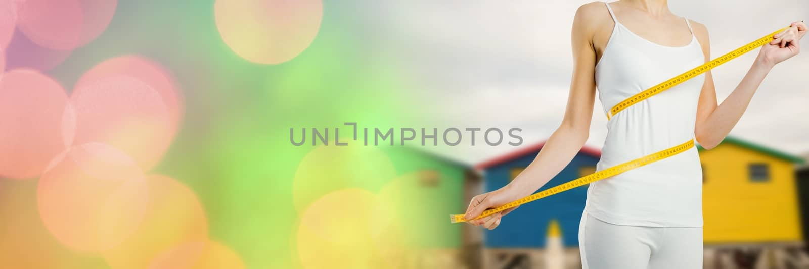 Digital composite of Woman measuring weight with measuring tape on waist near Summer beach huts with transition