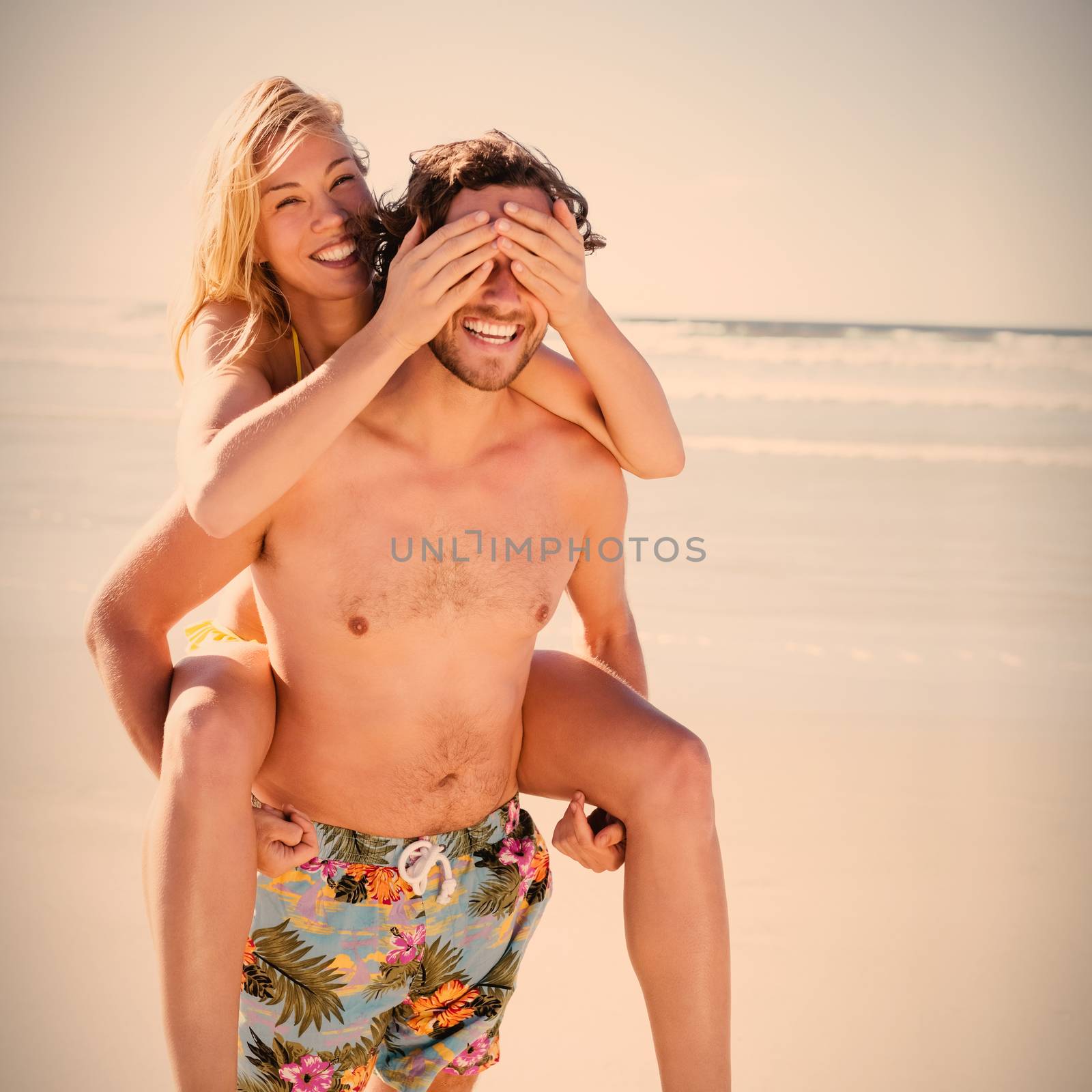 Happy couple enjoying at beach by Wavebreakmedia
