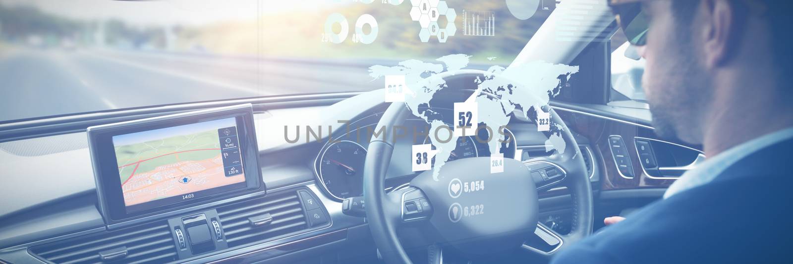 Global technology background against man behind the wheel wearing sunglasses