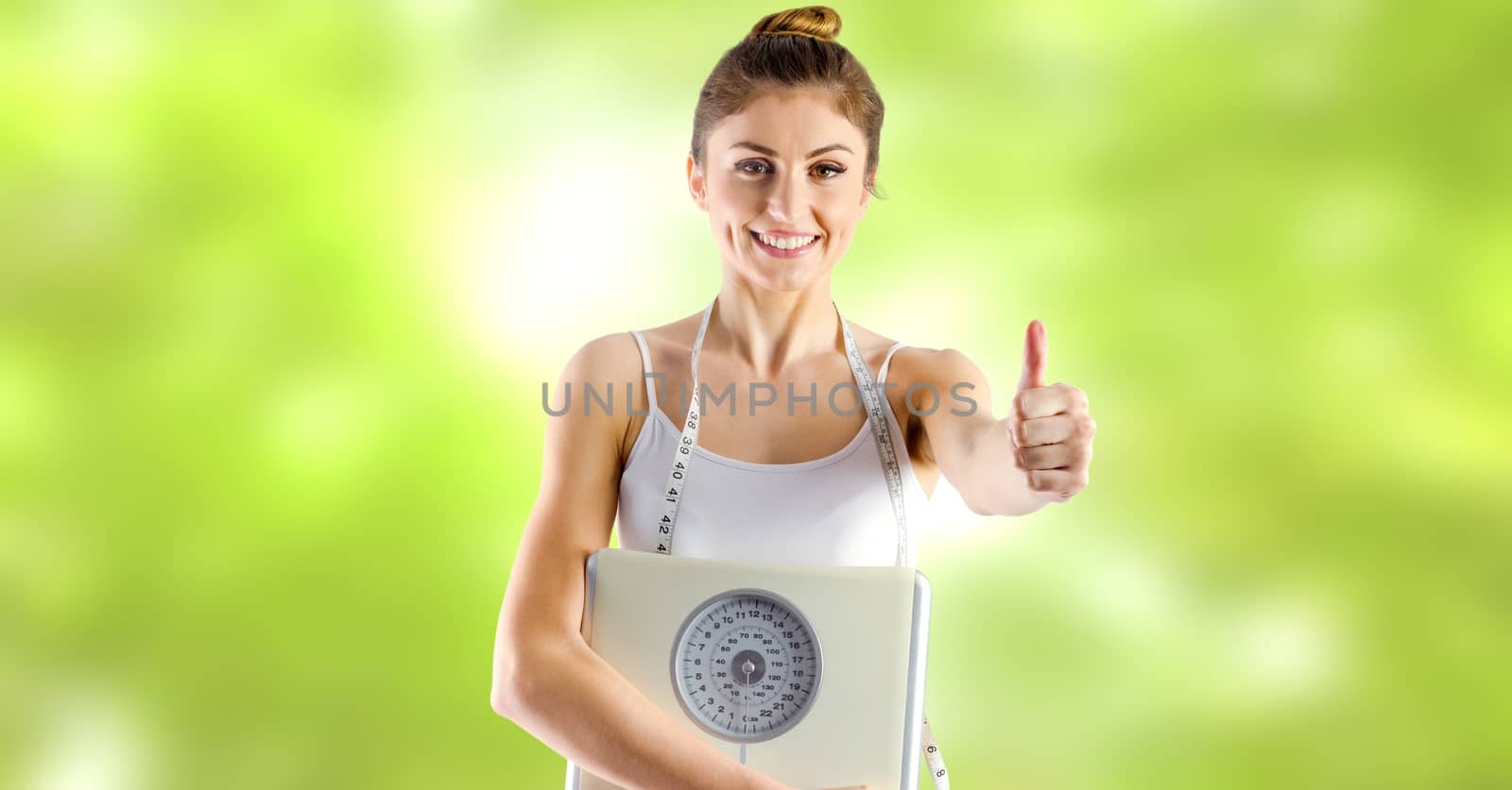 Woman holding weighing scales in Summer by Wavebreakmedia