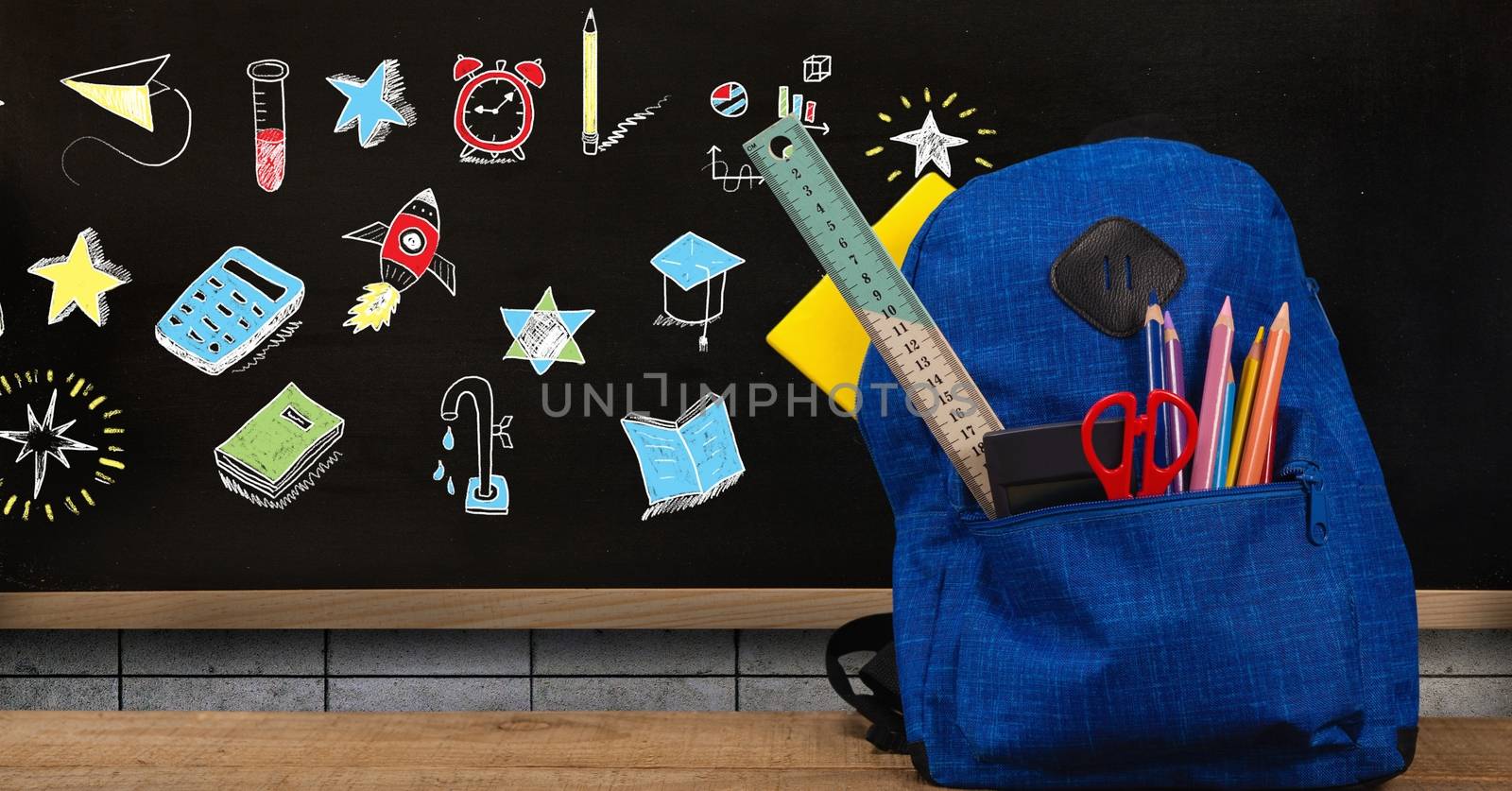 Schoolbag and Education drawing on blackboard for school by Wavebreakmedia