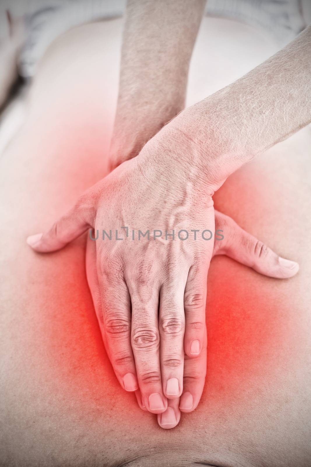 Highlighted pain against physiotherapist doing back massage to her patient