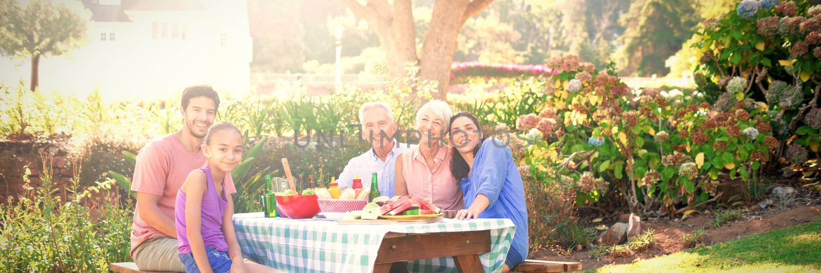 Portrait of happy family having barbecue in the park