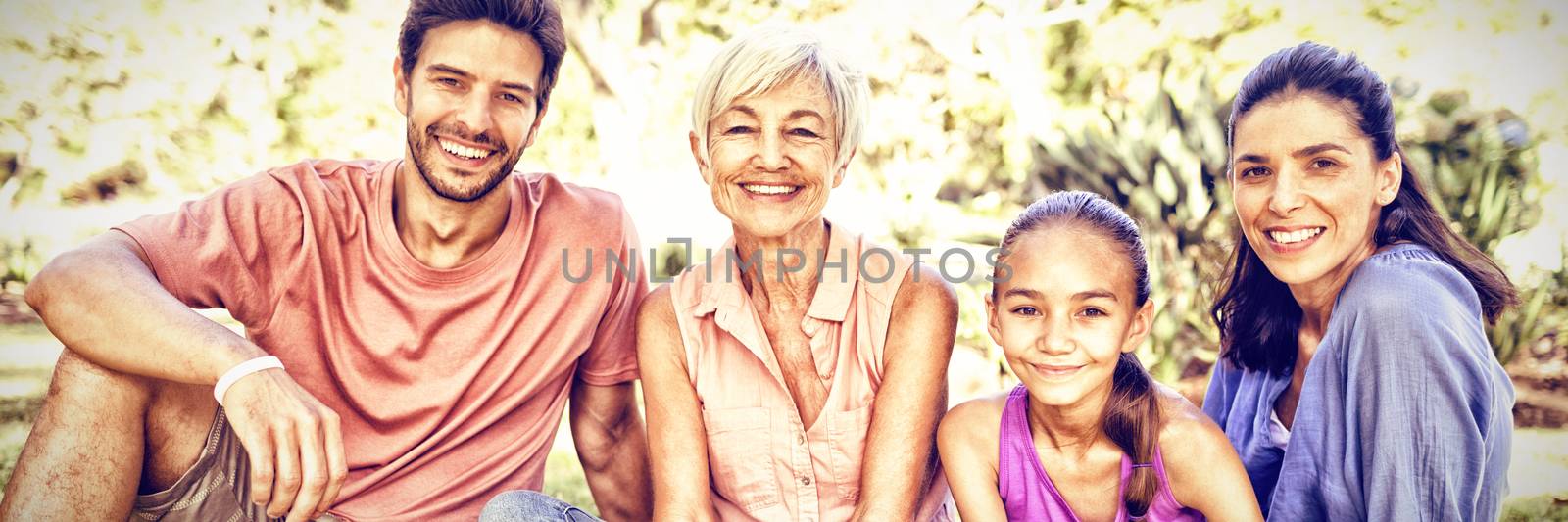 Portrait of happy family sitting in the park