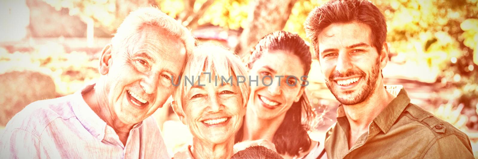 Portrait of happy family standing together in the park