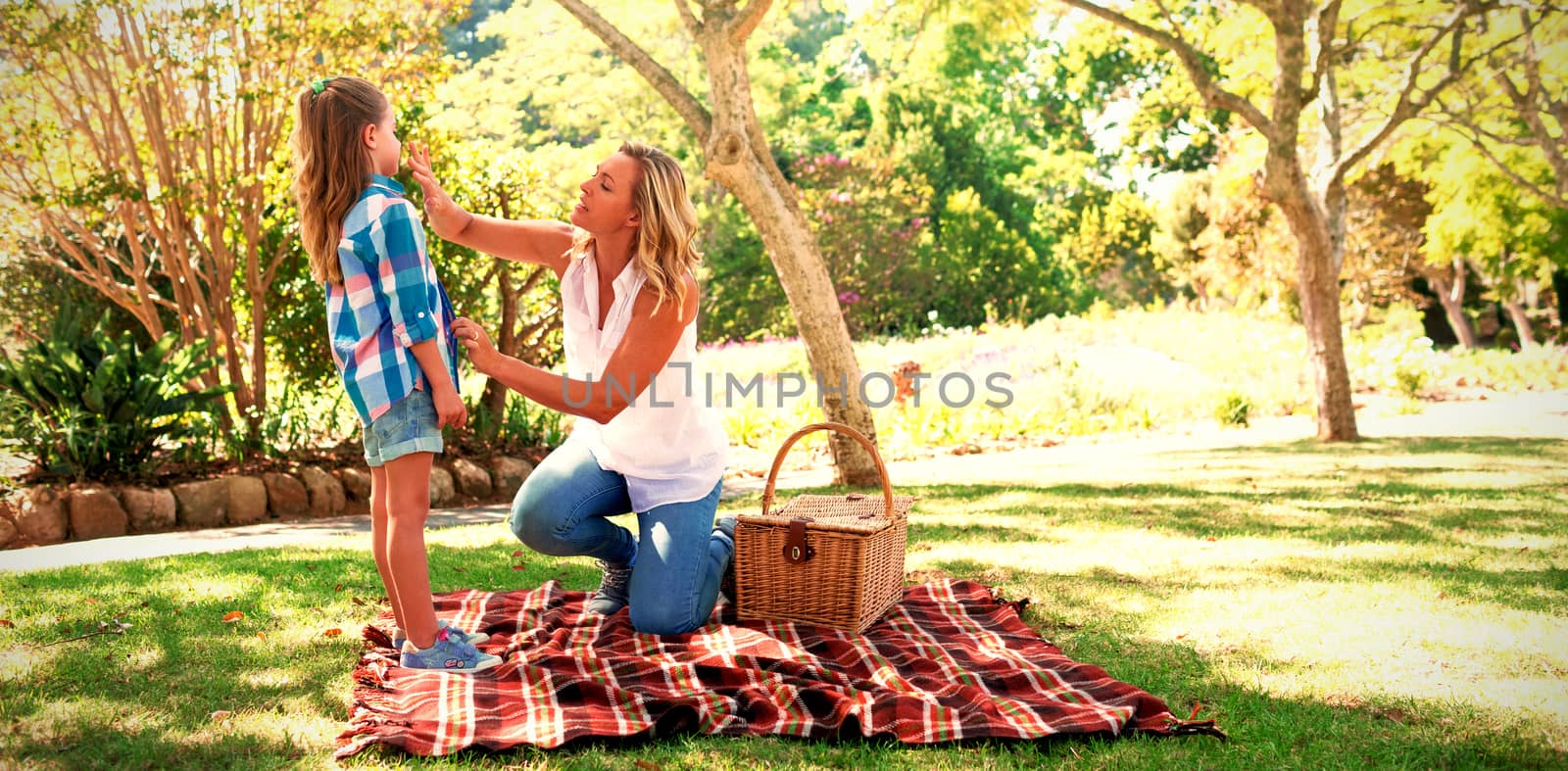 Mother talking to her daughter in the park while having picnic