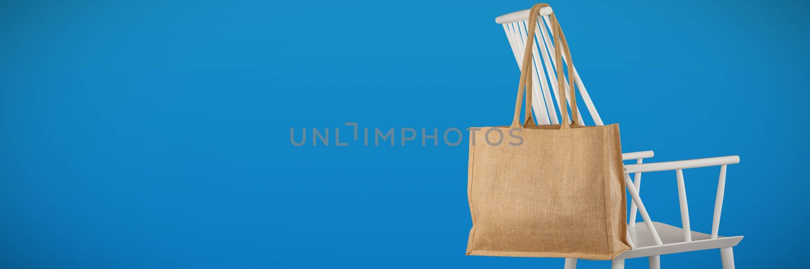 Canvas bag against abstract blue background