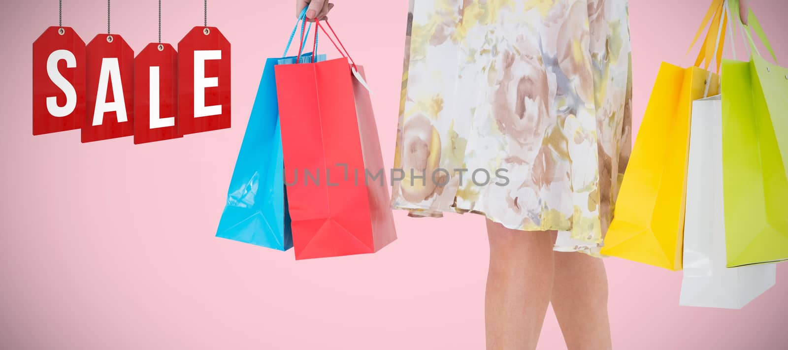 Elegant woman holding shopping bag against pink background 