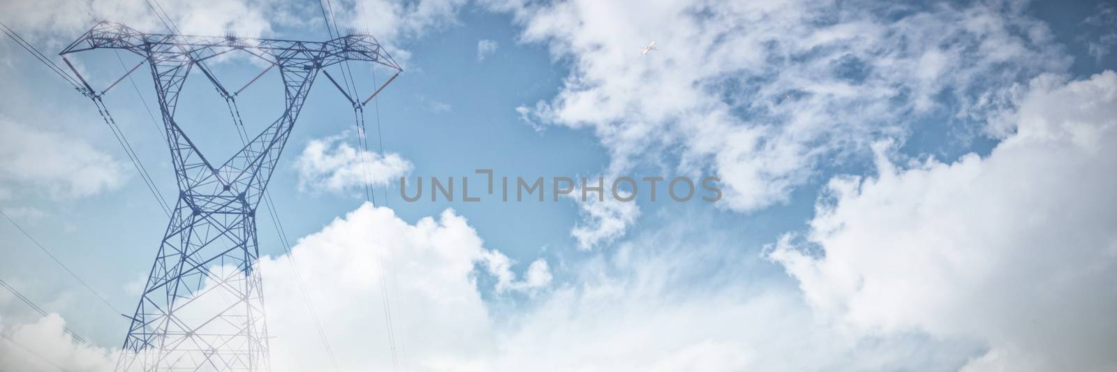 Sky and cloud on a sunny day against the evening electricity pylon silhouette