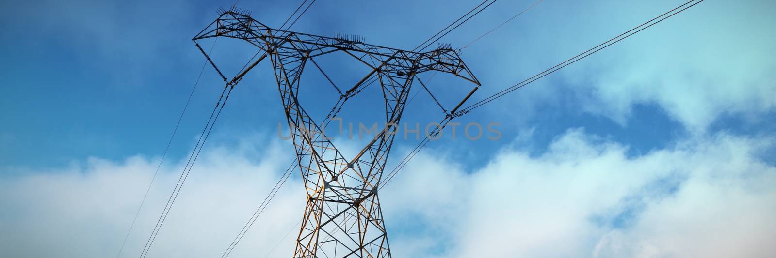 Blue sky with clouds against the evening electricity pylon silhouette