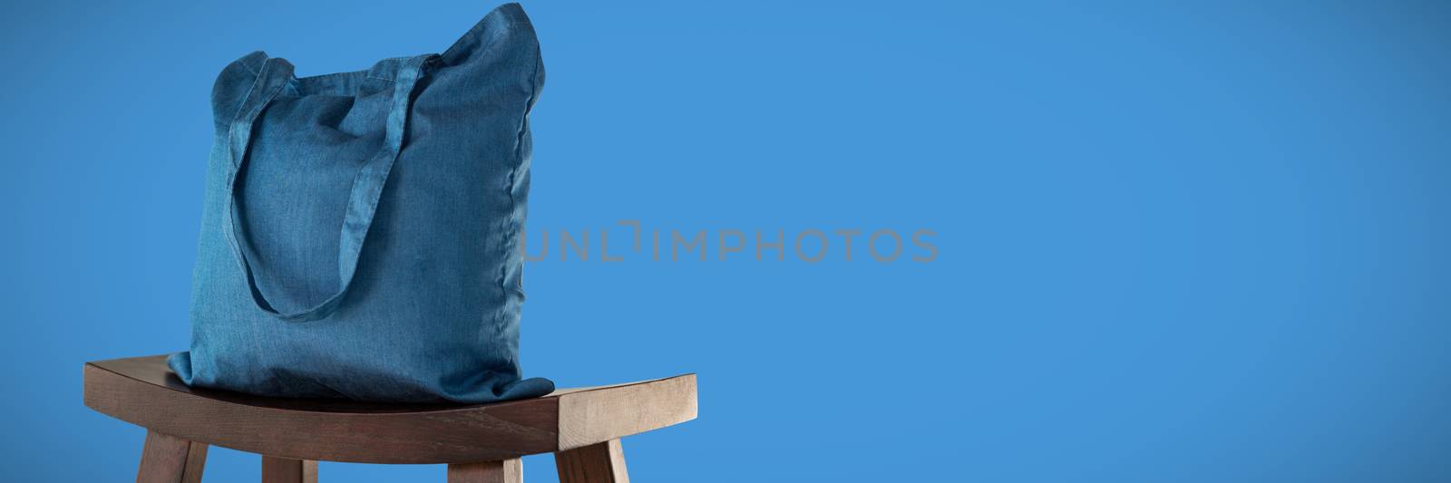 Canvas bag against blue background