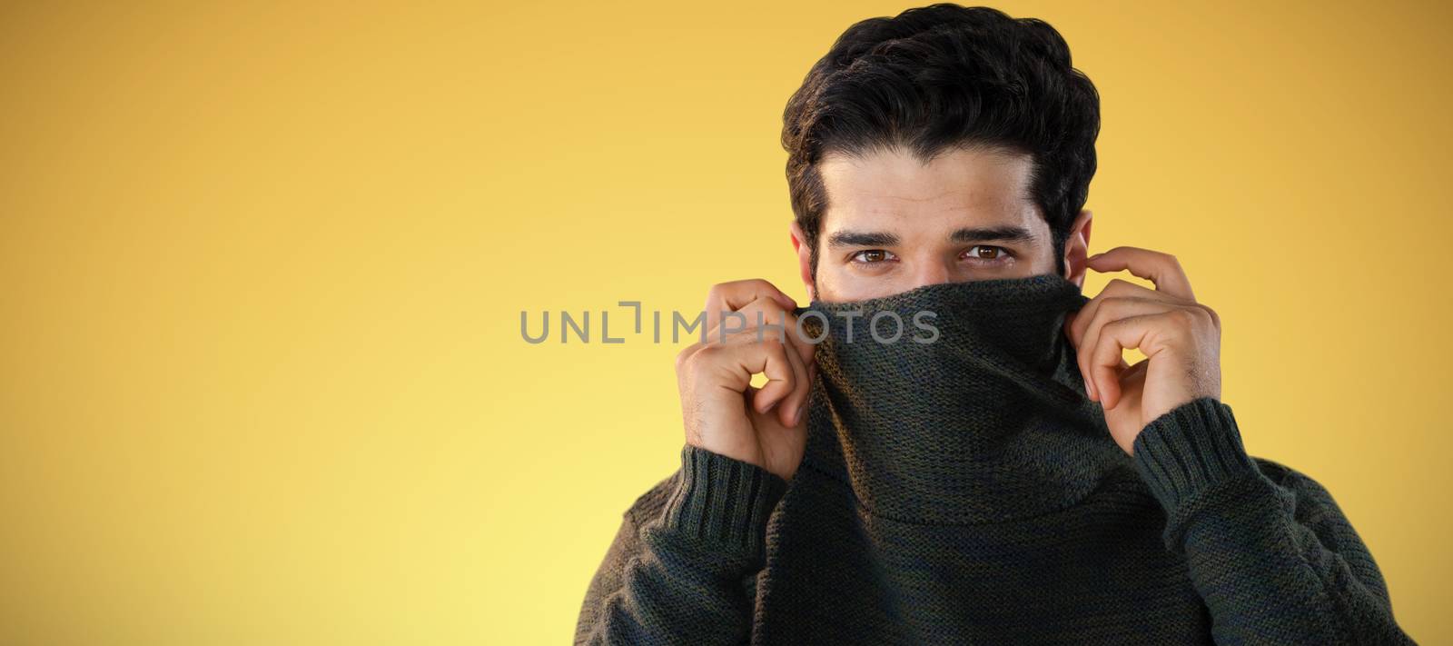 Composite image of portrait of man hiding face with sweater by Wavebreakmedia