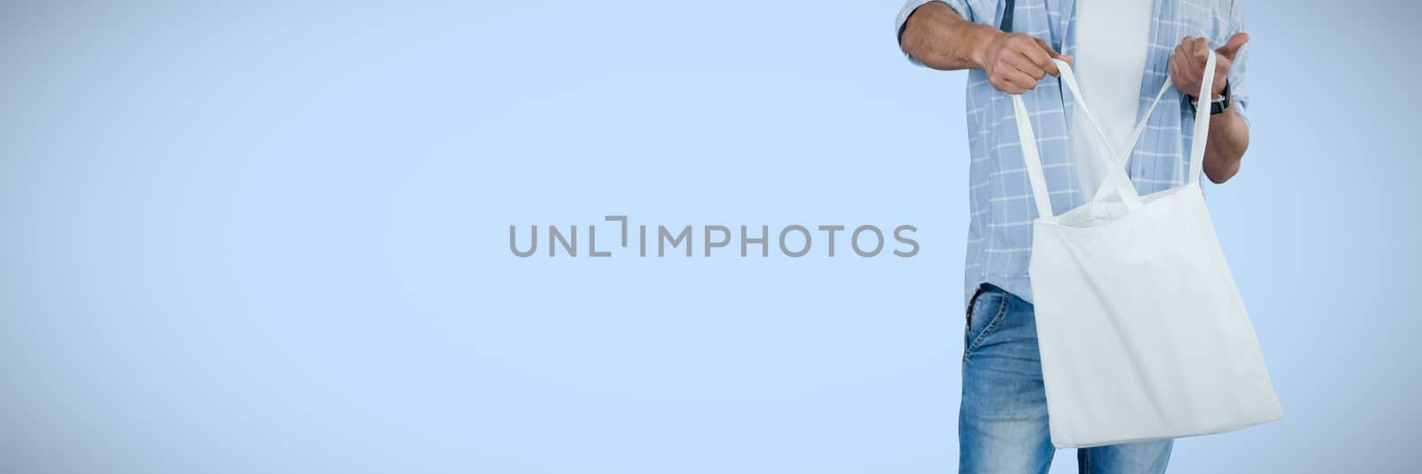 Man holding shopping bag against white background against blue background