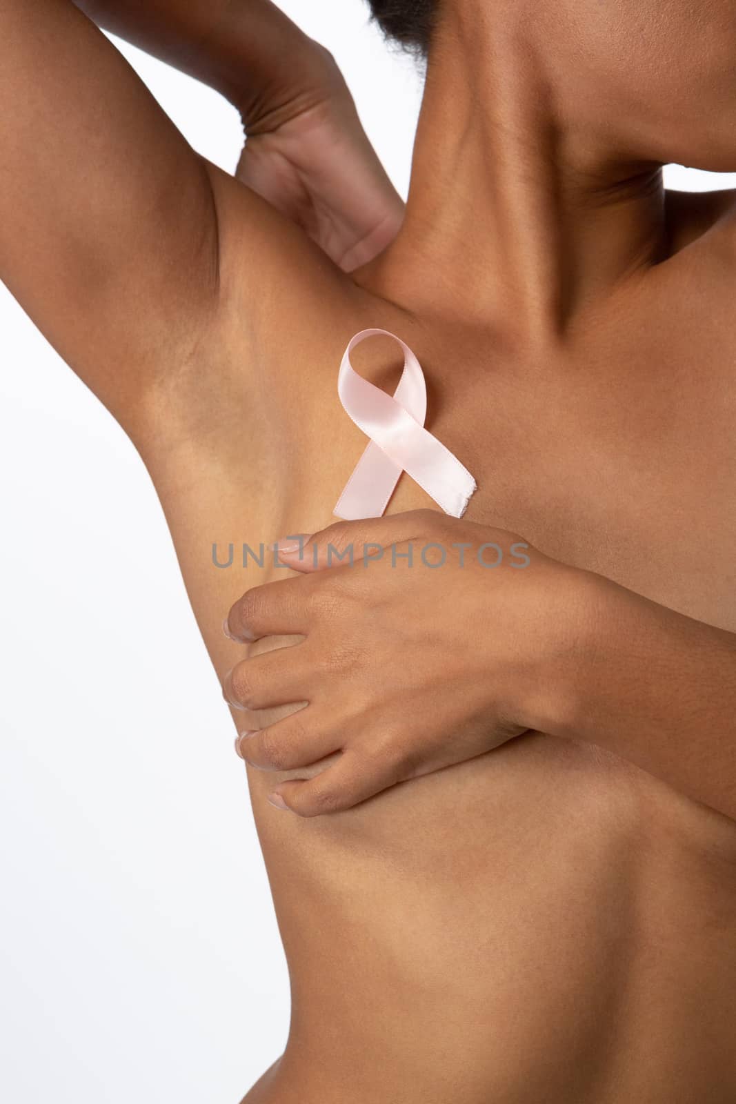 Shirtless woman for breast cancer awareness with ribbon on white background