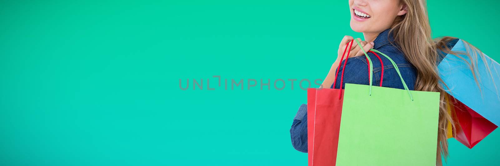 Woman holding shopping bags against abstract green background