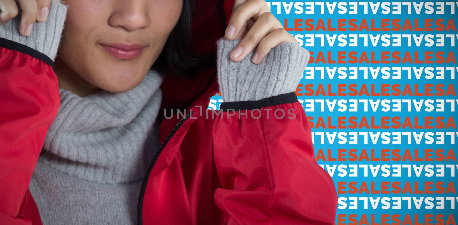 Smiling woman in hooded jacket standing against white background against blue background