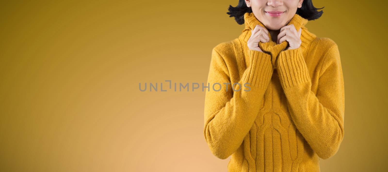 Woman in winter clothing posing against white background against abstract blue background